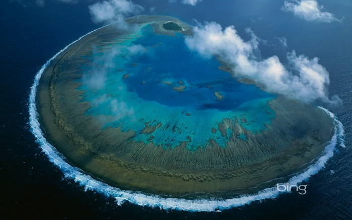 Aerial view of a coral reef with clouds