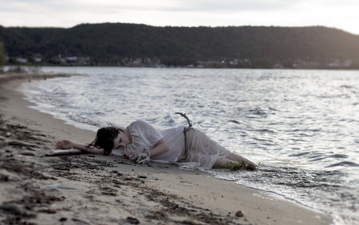 Woman lying on a beach by the sea