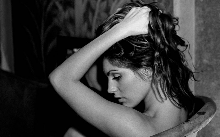 Monochrome portrait of a woman with hands in her hair