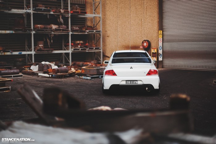 White Mitsubishi Lancer EVO in industrial area
