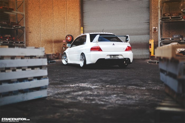 White Mitsubishi Lancer Evolution parked in a warehouse