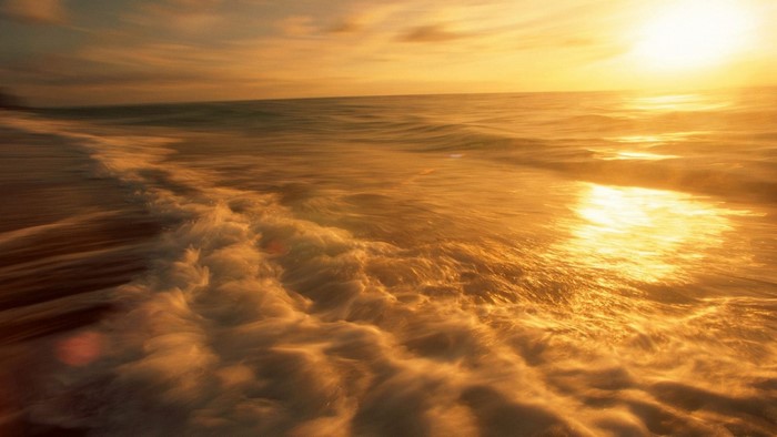Golden sunset over the ocean waves