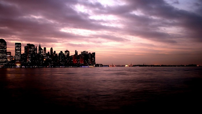 City skyline at dusk over the water