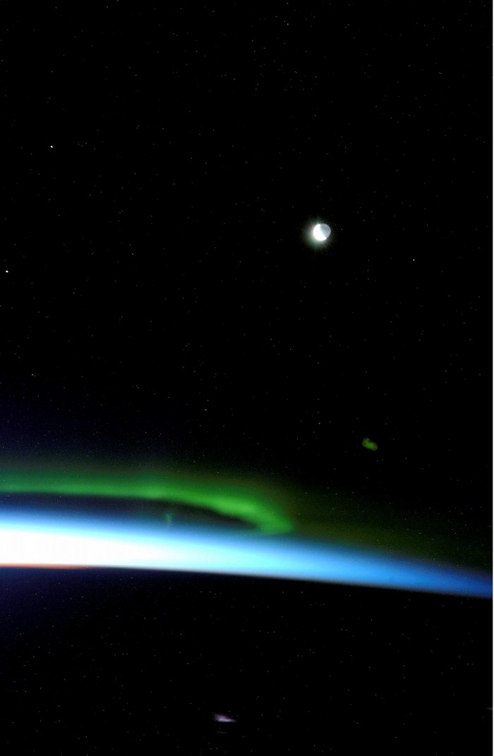Aurora Borealis over Earth with Moon and Stars