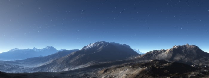 Panoramic view of a mountain range under a starry sky