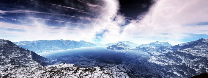 Snowy mountains and a lake under a cloudy sky