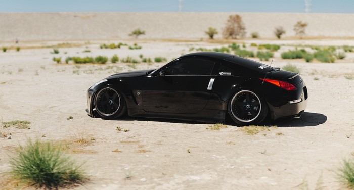 Black Nissan 350Z sports car on sandy terrain