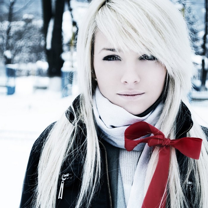 Woman with white hair and red ribbon in snow