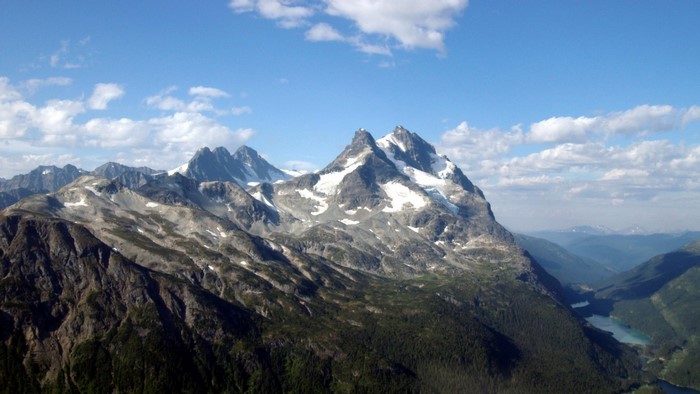 Snow-capped mountains and a turquoise lake in a valley