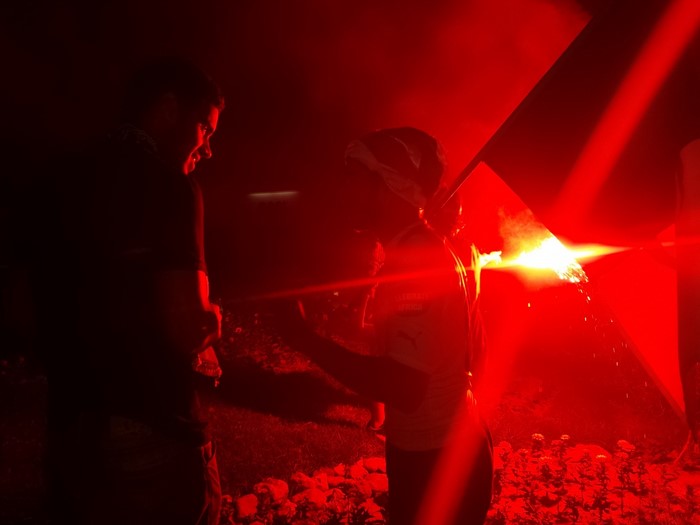 People with red flare at night