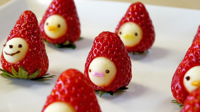 Strawberry penguins on a white plate