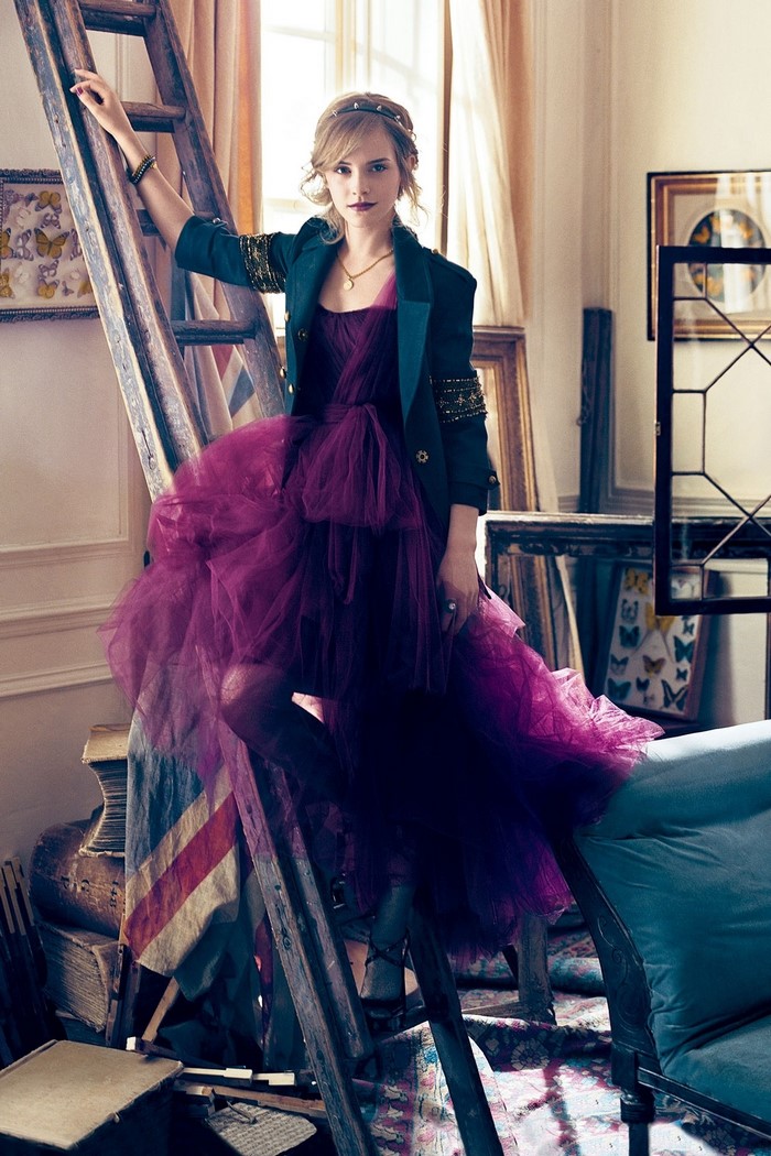Emma Watson in a purple dress and blue jacket