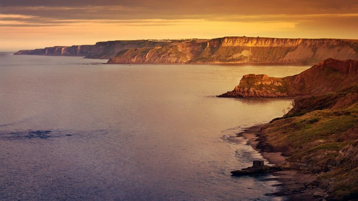 Sunset Over Rocky Coastal Cliffs