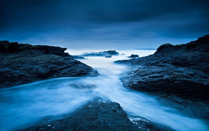 Long exposure of rocky coast with ocean waves