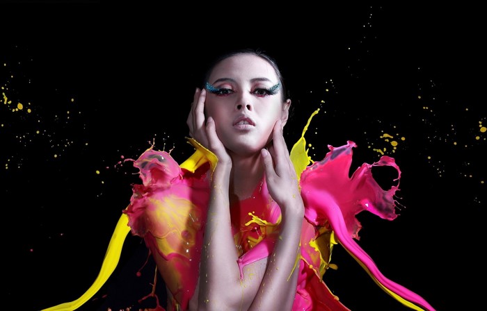 Woman with pink and yellow paint splashes
