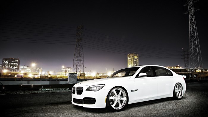 White BMW Sedan with Custom Wheels at Night