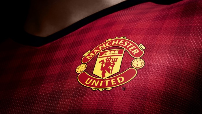 Manchester United football club logo on red jersey