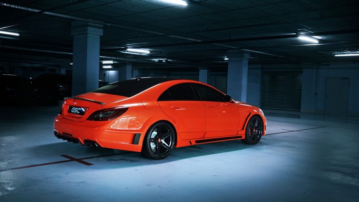Orange Mercedes-Benz CLA with custom body kit in a parking garage