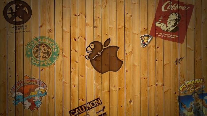 Apple logo with stickers on wood