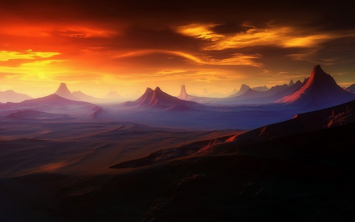 Mountainous landscape at sunset with dramatic sky