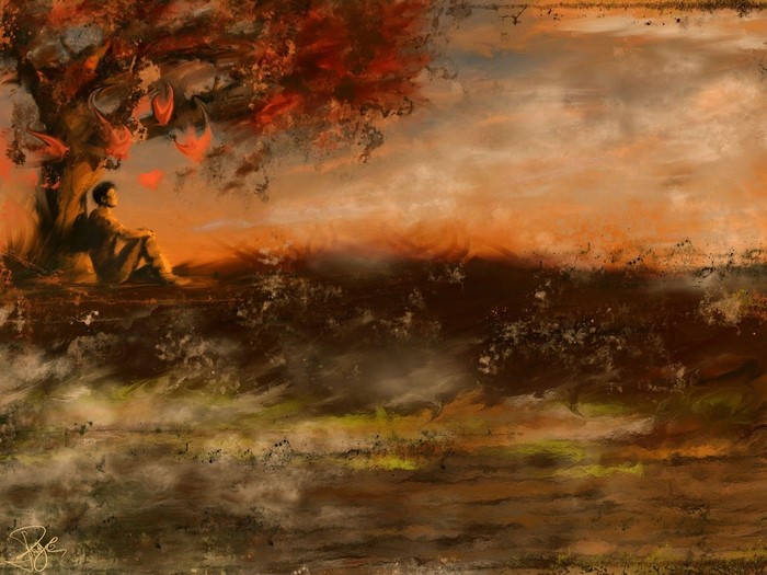 Person sitting under a tree during sunset