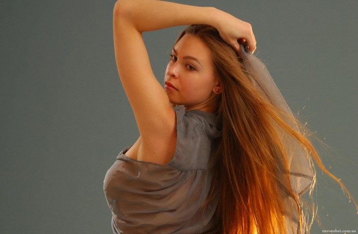 Woman with long brown hair posing