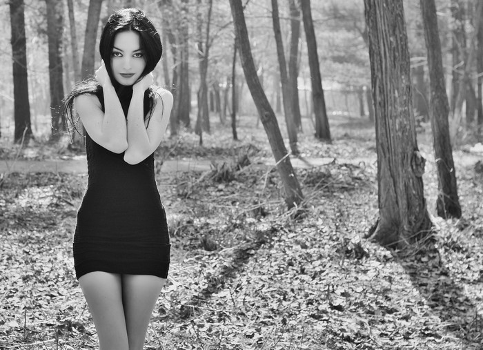 Woman in black dress in a forest