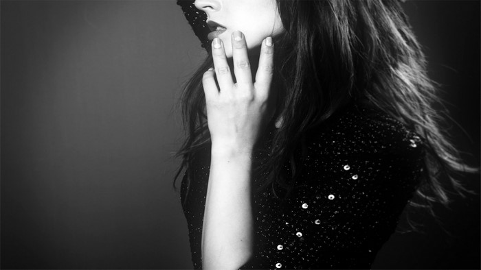 Monochrome portrait of a woman with hand on face