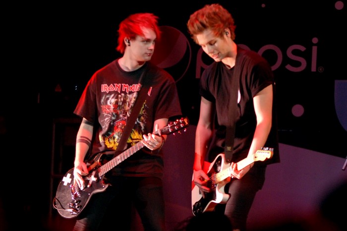 5 Seconds of Summer band members performing on stage