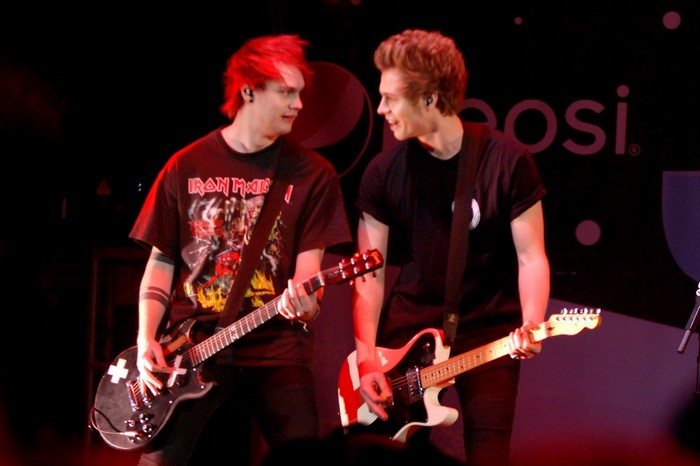 5 Seconds of Summer band members performing on stage