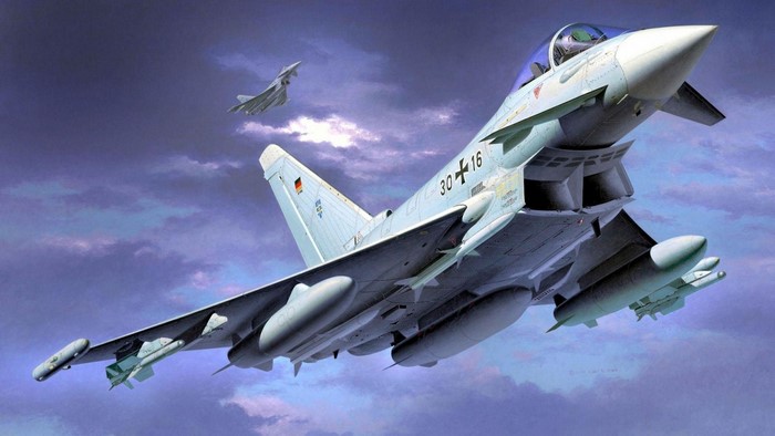 Eurofighter Typhoon fighter jets flying in cloudy sky