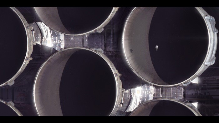 Astronaut floating near rocket engines