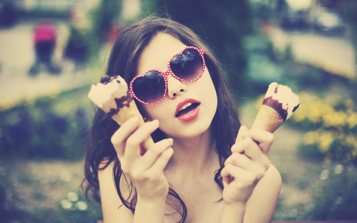 Woman Wearing Heart-Shaped Sunglasses Holding Ice Cream