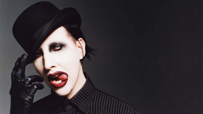 Marilyn Manson wearing a top hat and gloves