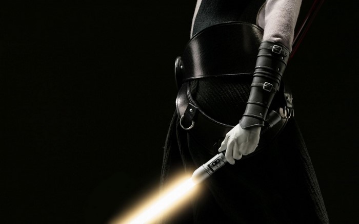 Star Wars character holding a yellow lightsaber