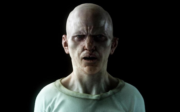 Bald man with angry expression in white shirt