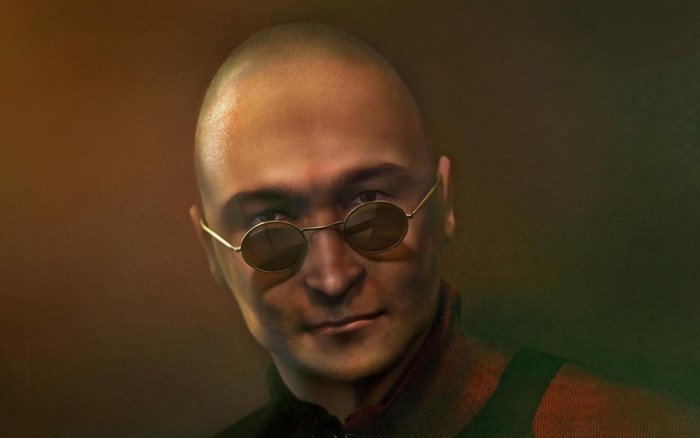 Bald man with round sunglasses wearing a red scarf