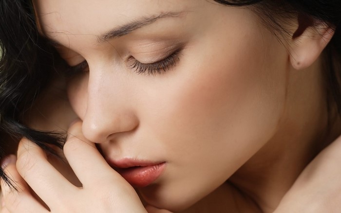 Close-up portrait of a woman with closed eyes