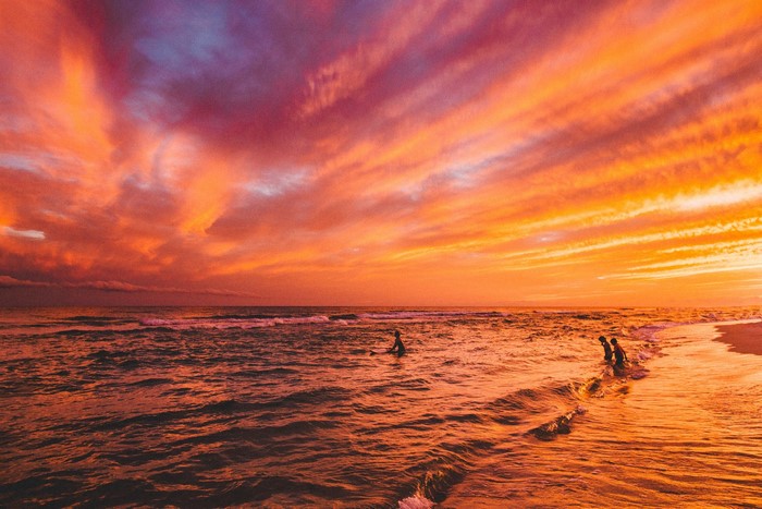 Fiery Sunset Over Ocean Shoreline