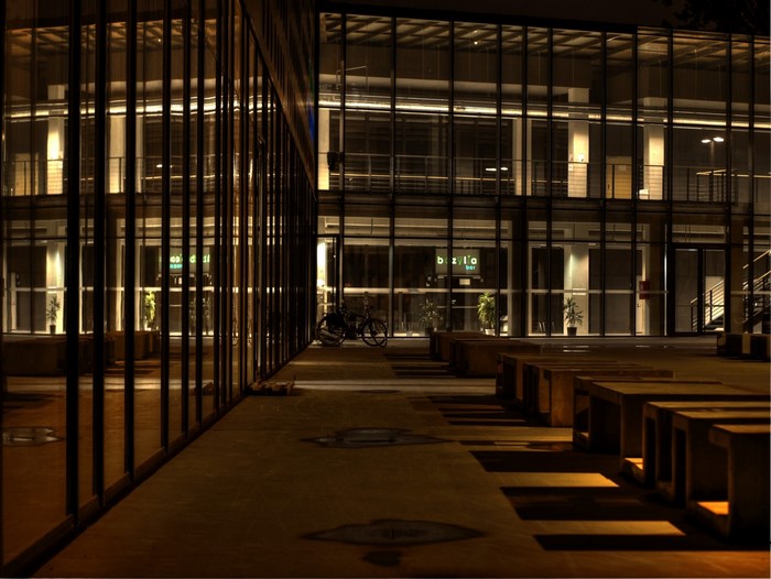 Modern architecture at night with concrete benches