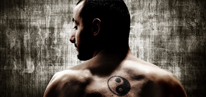 Man with Yin and Yang tattoo on back