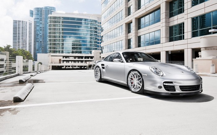 Silver Porsche 911 Turbo parked in a city parking garage