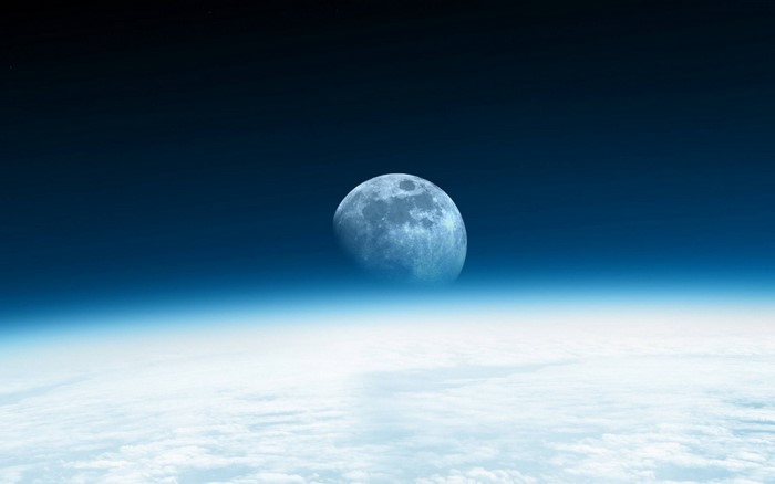 Moon over Earth's atmosphere and clouds
