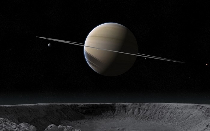 Saturn and its moons from a cratered surface