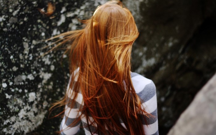 Woman with long red hair and striped shirt