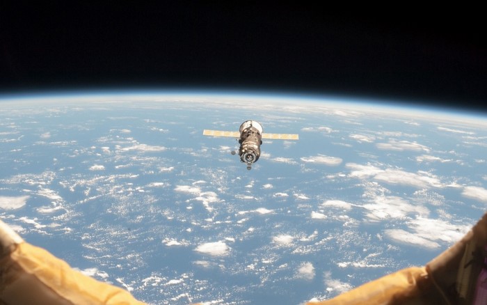 Spacecraft orbiting Earth with solar panels extended
