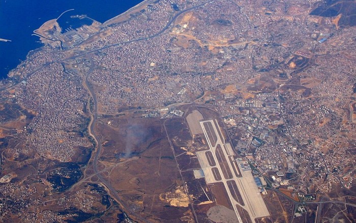 Aerial view of a coastal city with an airport