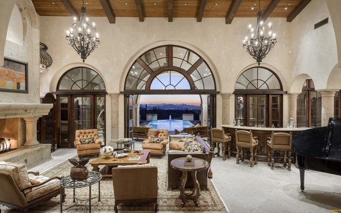 Luxury living room with fireplace and bar overlooking pool