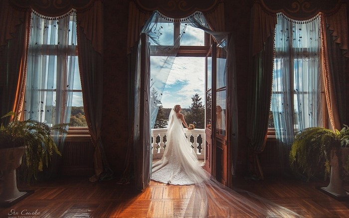 Bride on a balcony in a mansion