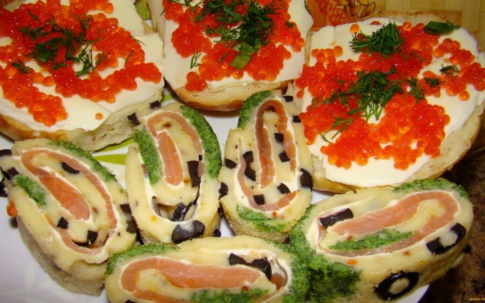 Appetizers with salmon rolls and red caviar sandwiches